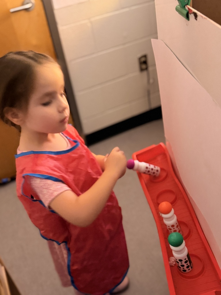 Painting in Mrs. Allen's PreK class.