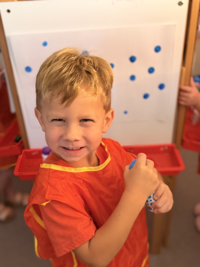 Painting in Mrs. Allen's PreK class.