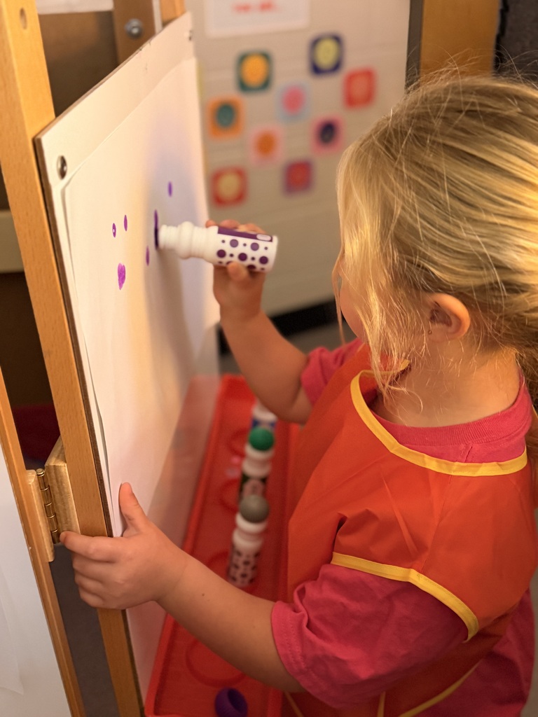 Painting in Mrs. Allen's PreK class.