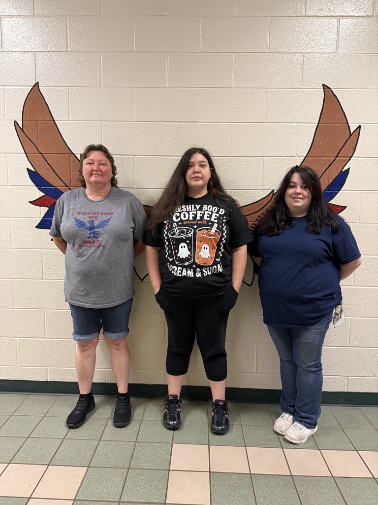 HES Custodians standing in front of an eagle