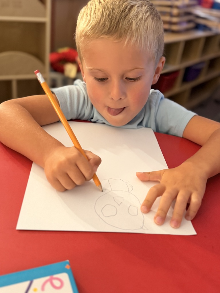Student in Mrs. Allen's PreK drawing a bat.