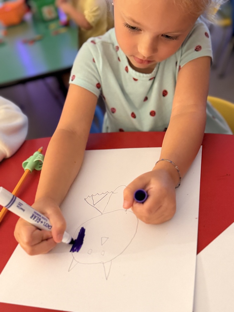Student in Mrs. Allen's PreK drawing a bat.
