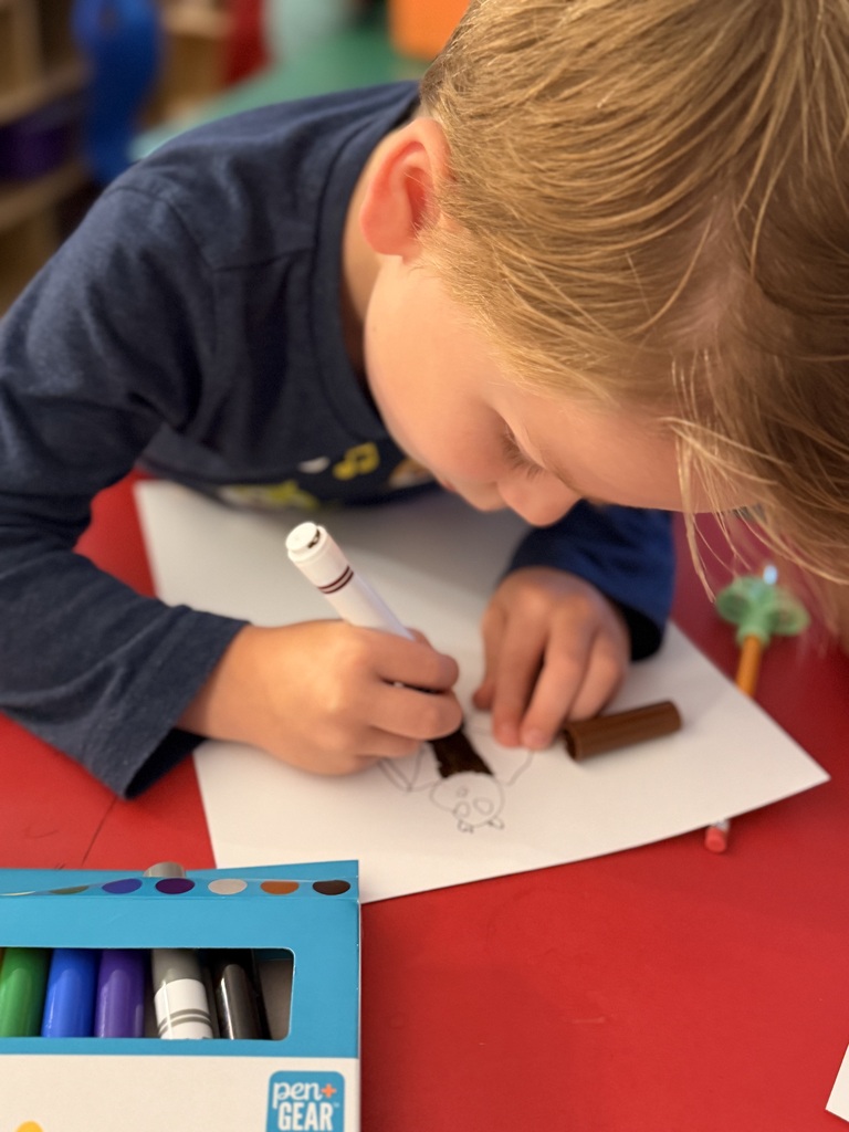Student in Mrs. Allen's PreK drawing a bat.