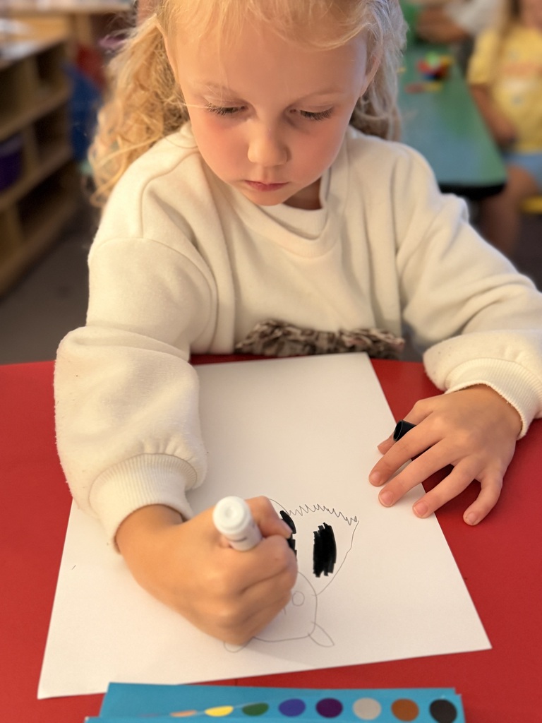 Student in Mrs. Allen's PreK drawing a bat.