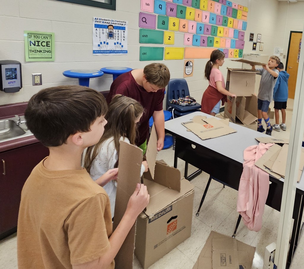 Building with cardboard in the computer lab.