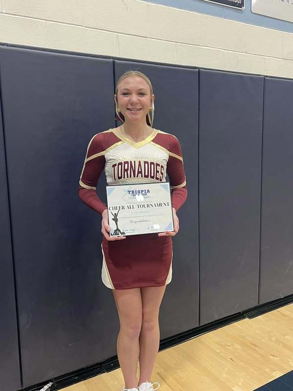 cheerleader smiling with award