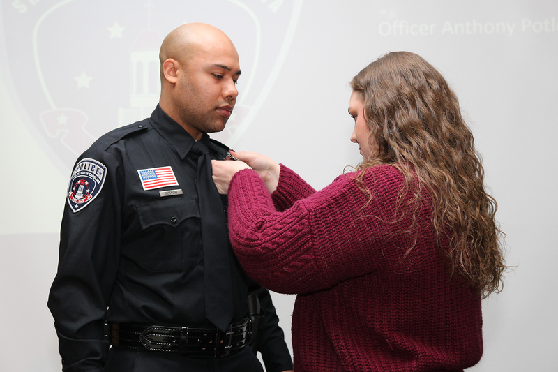 Officer Potlow being pinned with his badge