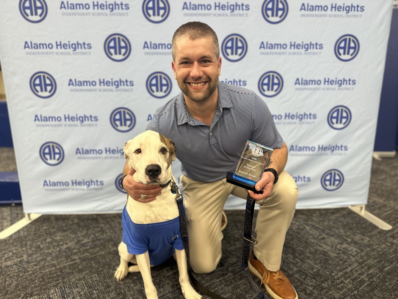 Brandon poses with service dog Buzz