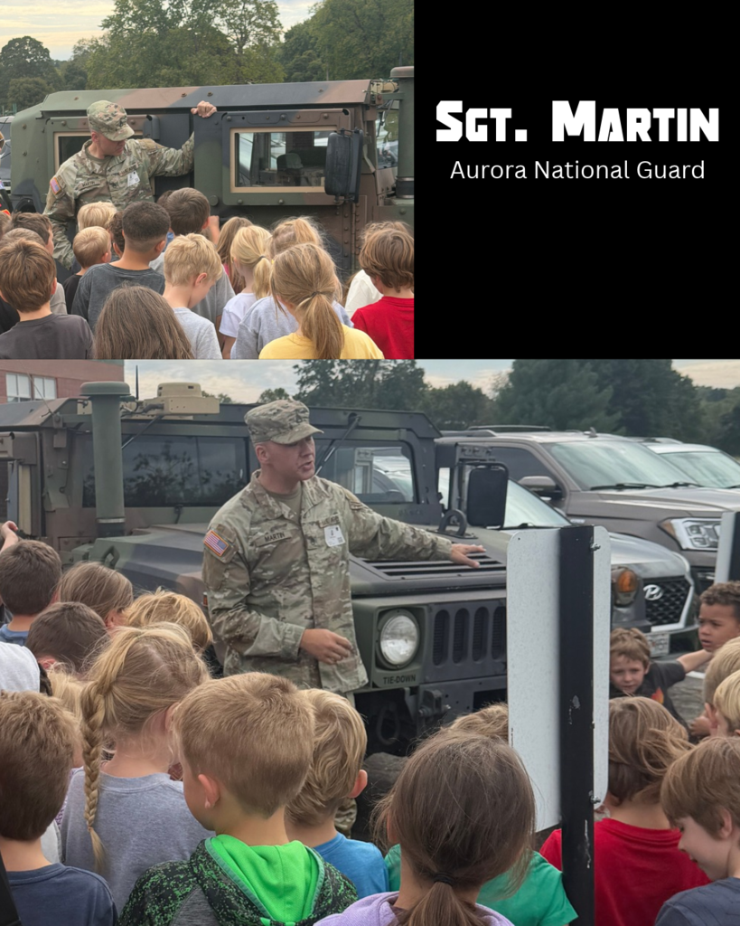 soldier talking to a group of children in front of a hummer