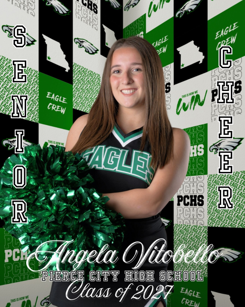 cheerleader holding green pompom in front of green, white, and black spirit wall