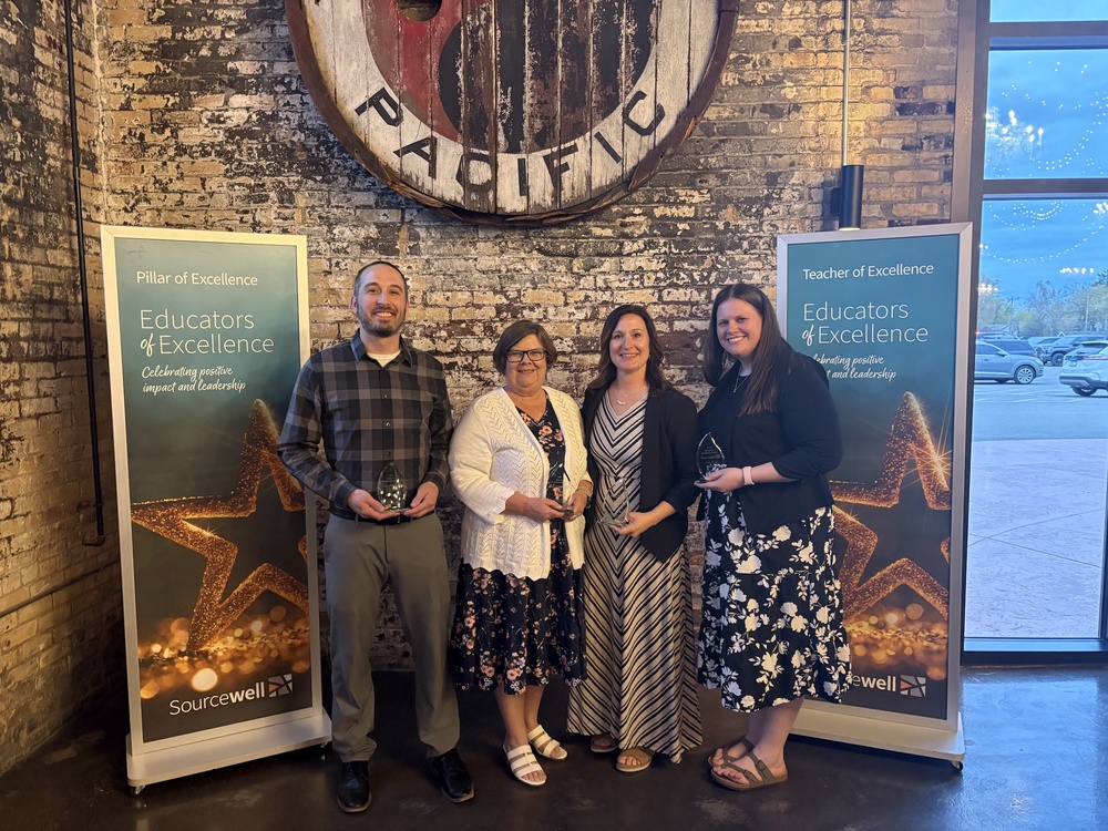 Educfators of excllence staff posed with awards at Pacific Railroad building