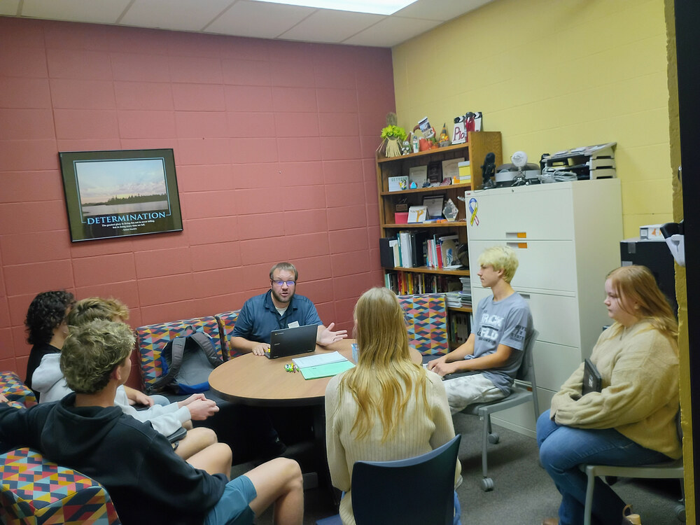 Students sitting with Joshua Zaborowski