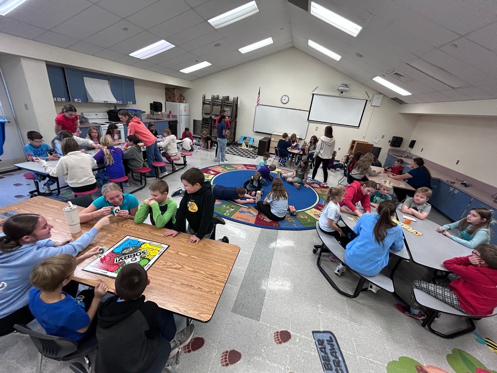 three students playing jenga