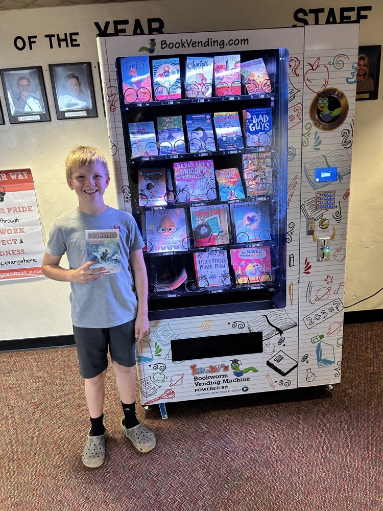 student in front of book vending machine 