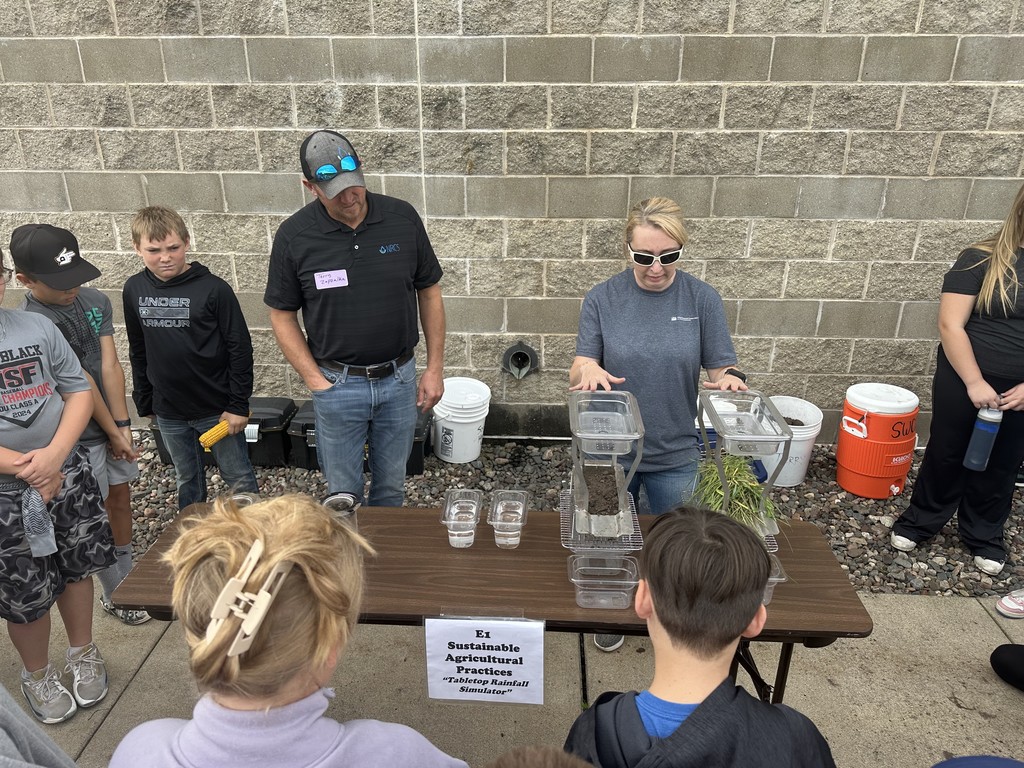 2 teachers talking to students outsdie of camp ripley