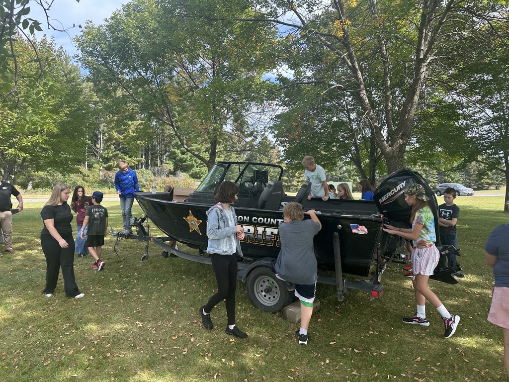 Sheriff boat surrounded by students on land
