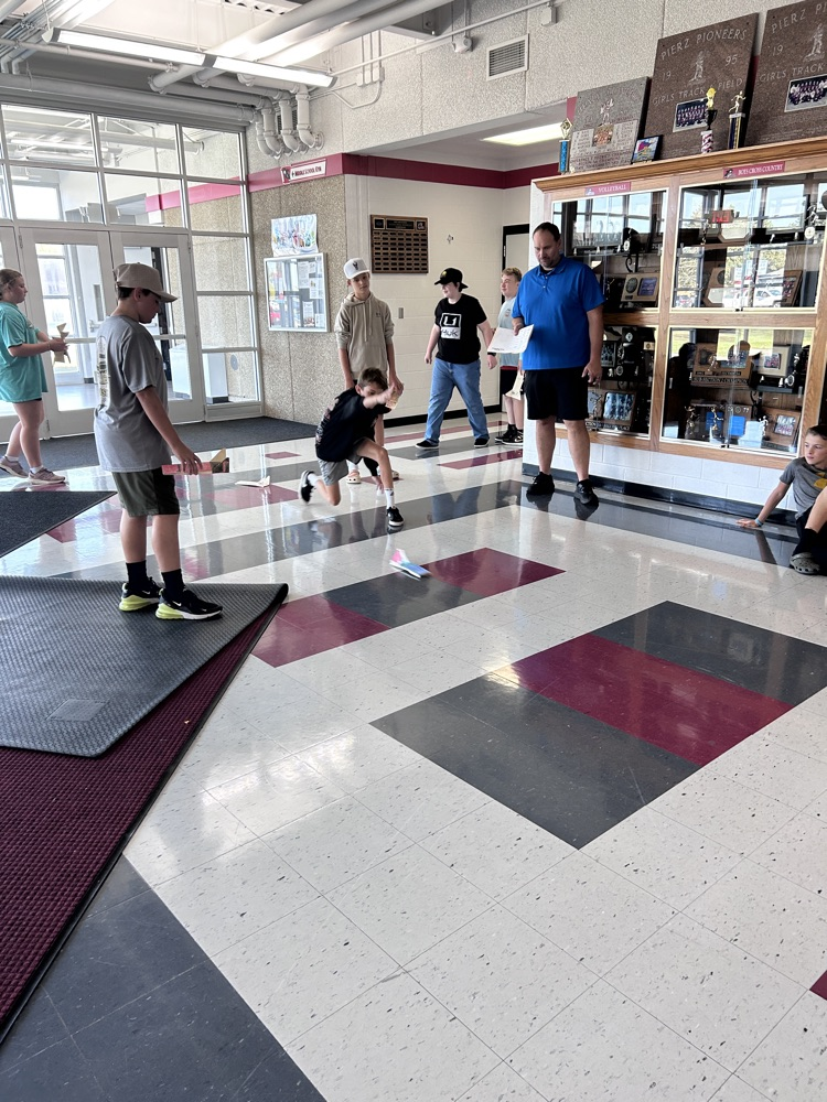student throwing paper rocket
