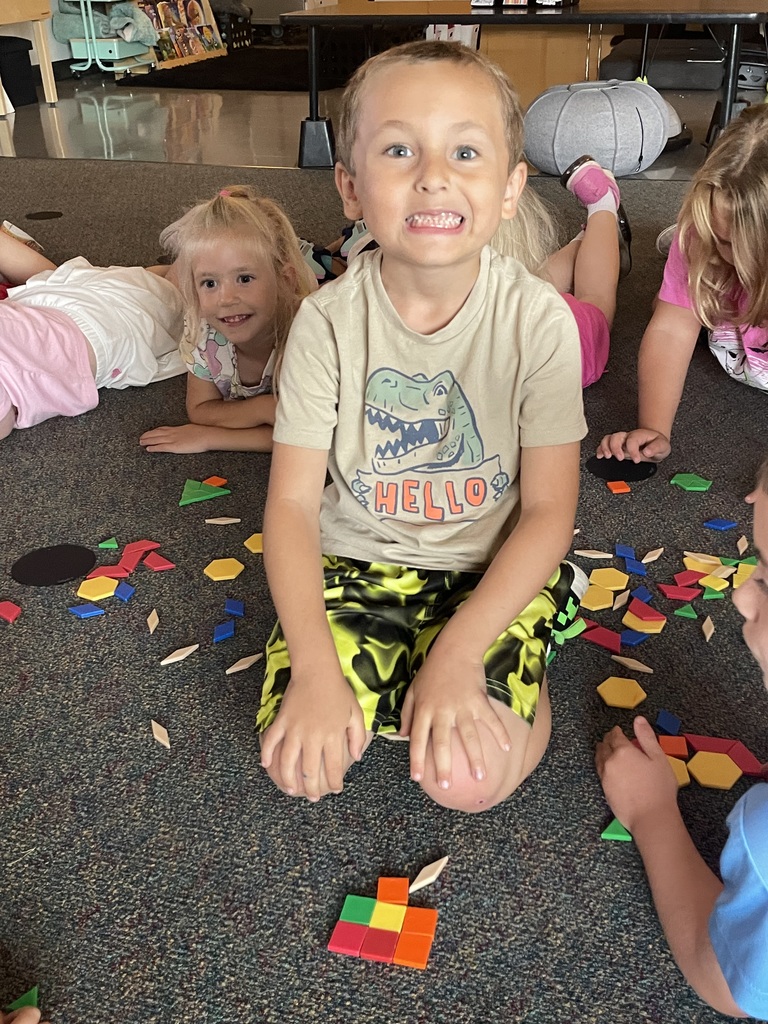 boy with short hair making a shape