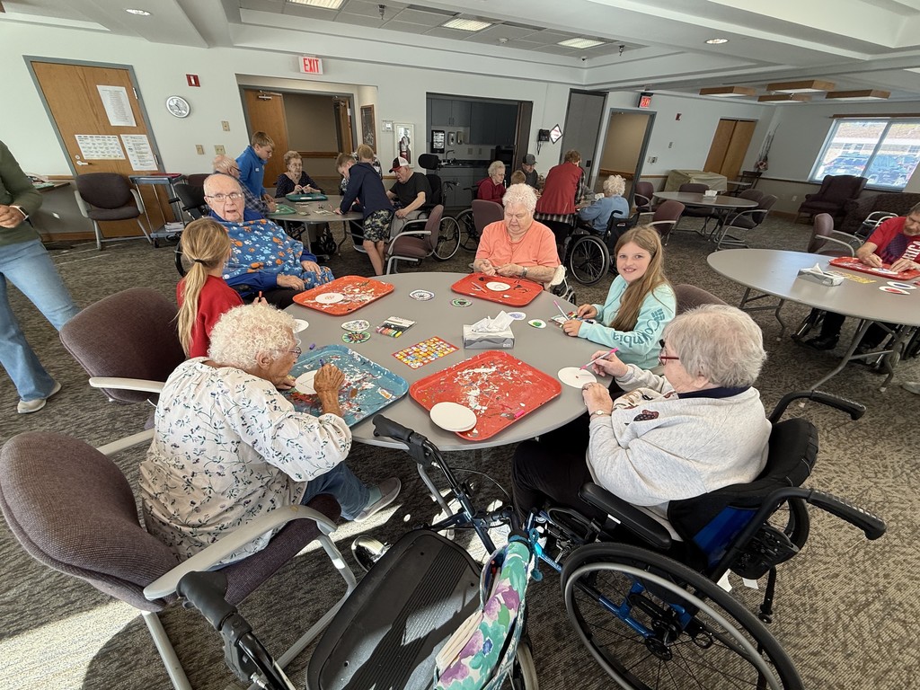 Students doing art with residents