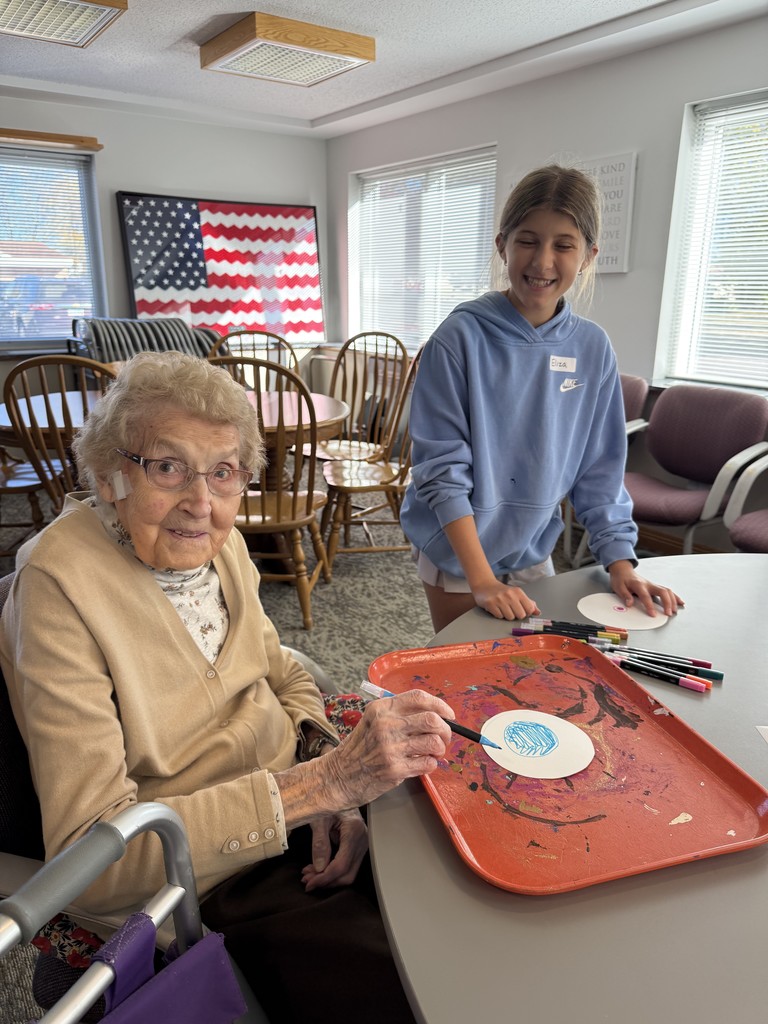 Students doing art with residents