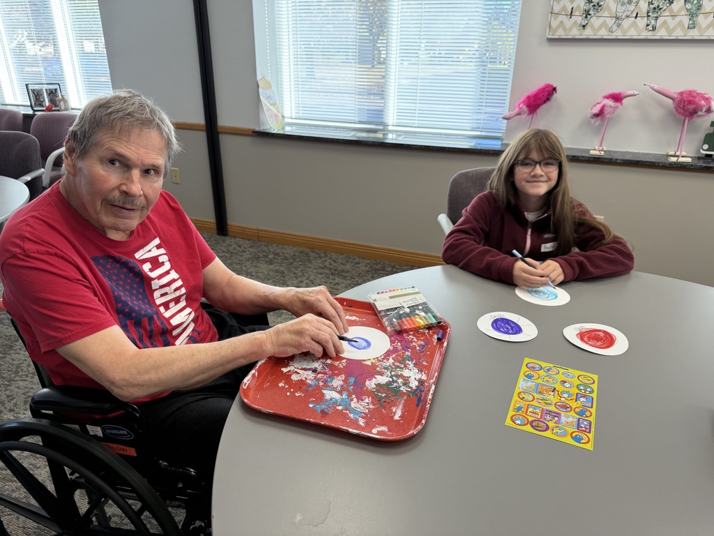 Students doing art with residents