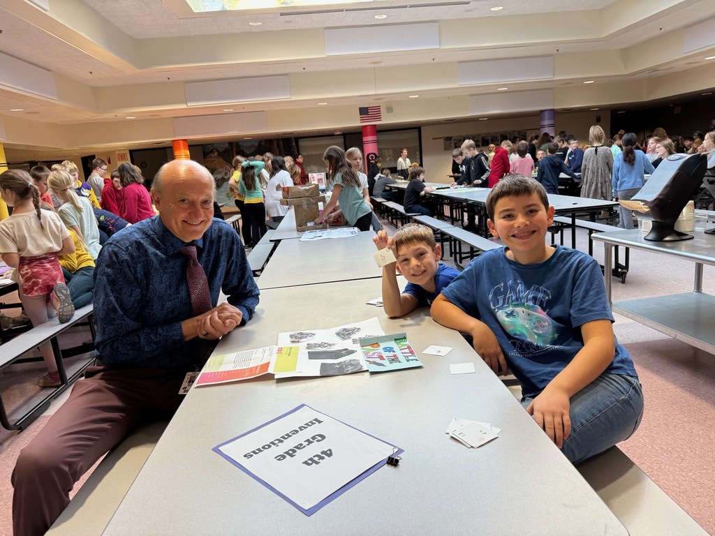 Mr. Weber with students in cafeteria 
