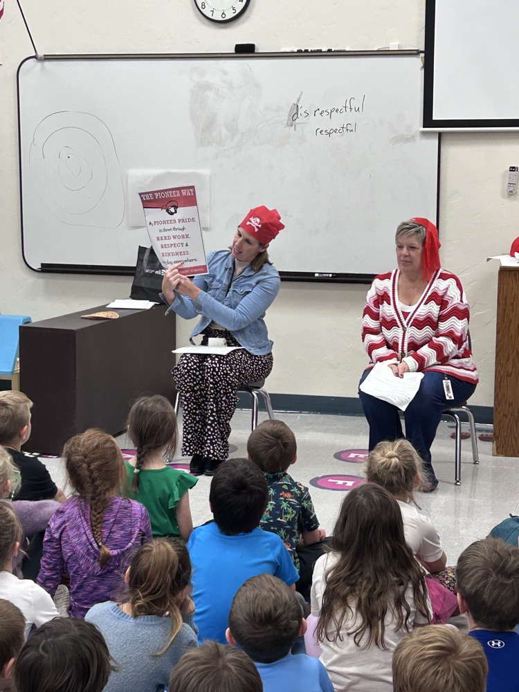 ms Becker and ms Ferguson talking to room of first graders 