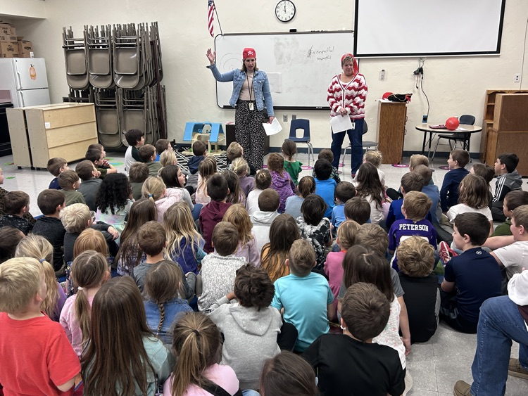 ms Becker and ms Ferguson talking to room of first graders 