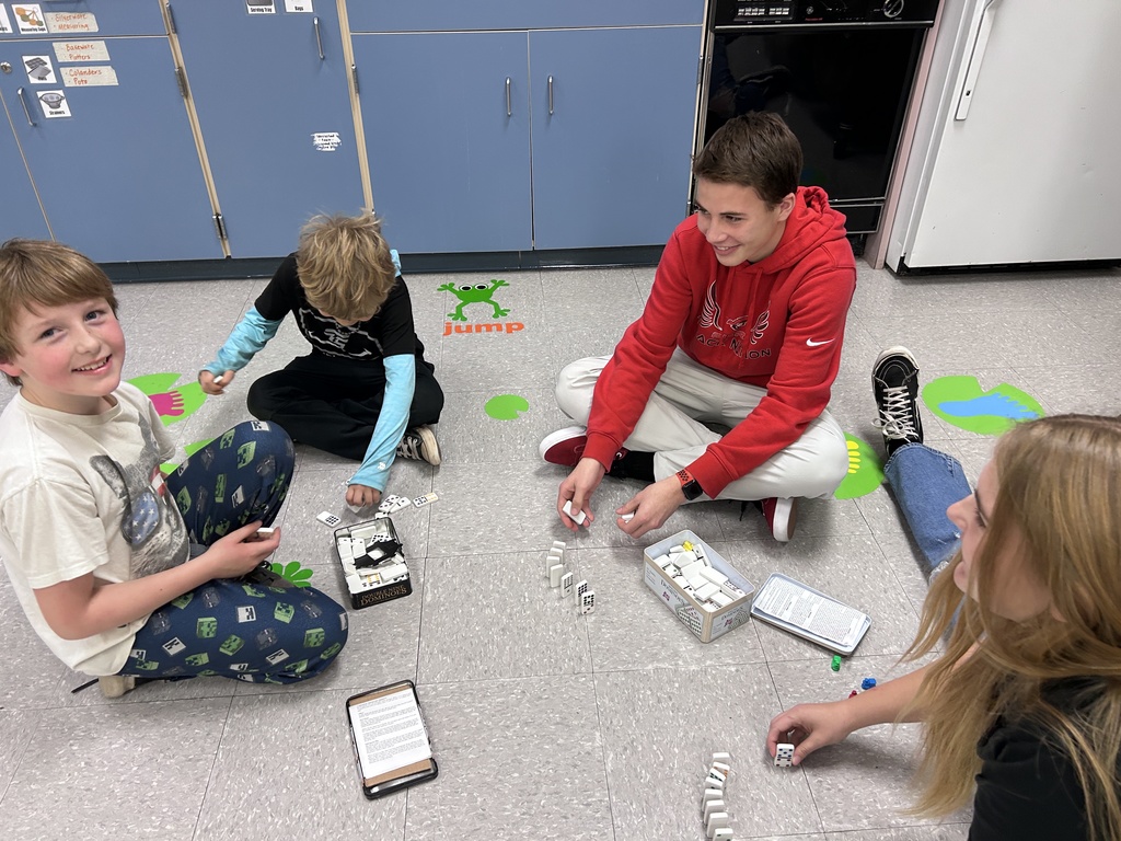 Group of ninth graders and 3rd graders playing games together