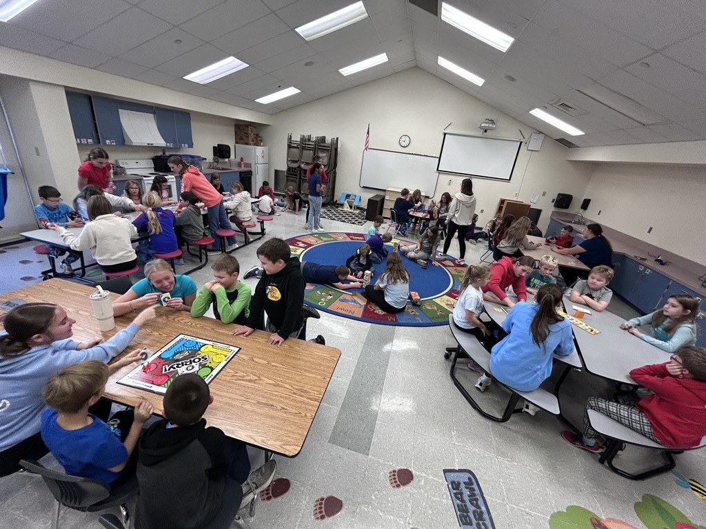 Group of ninth graders and 3rd graders playing games together