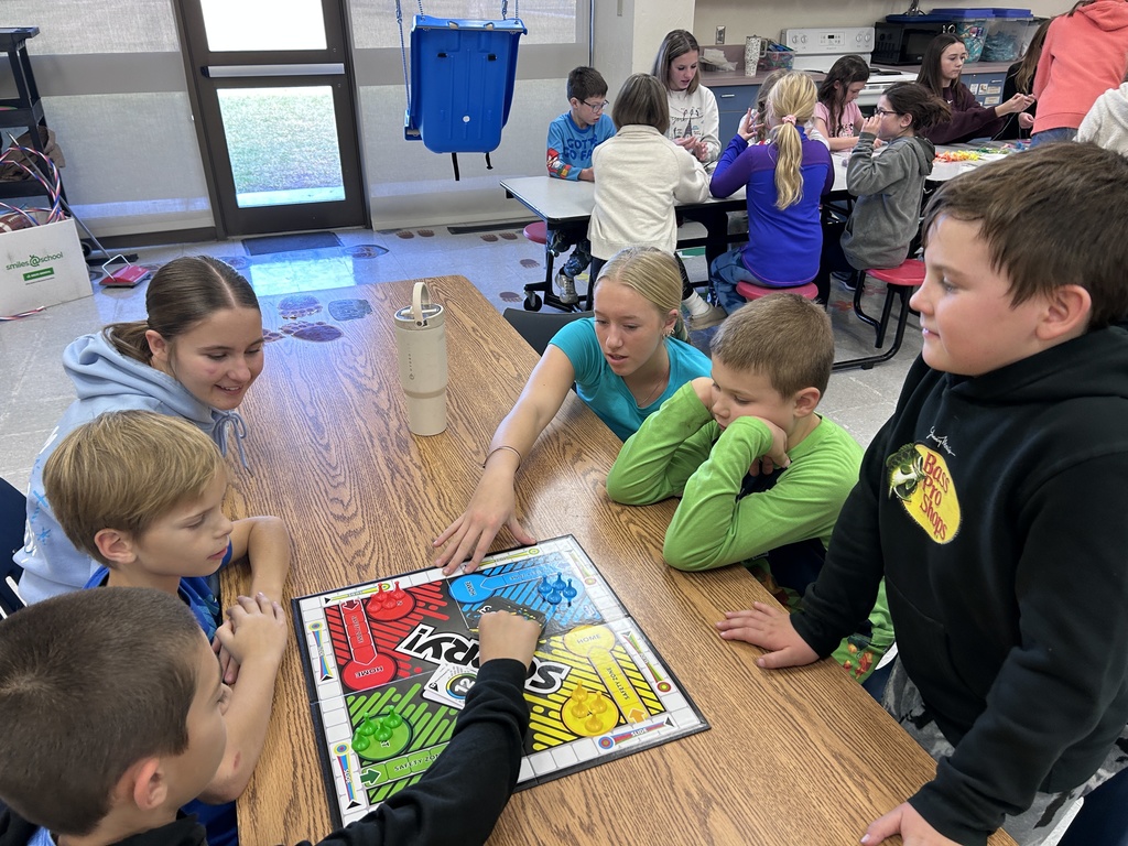 Group of ninth graders and 3rd graders playing games together