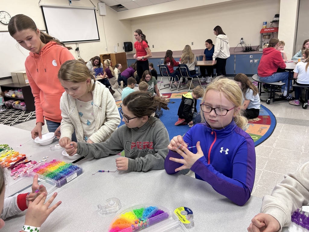 Group of ninth graders and 3rd graders playing games together
