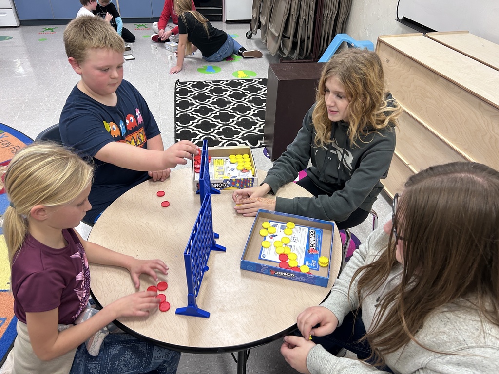 Group of ninth graders and 3rd graders playing games together