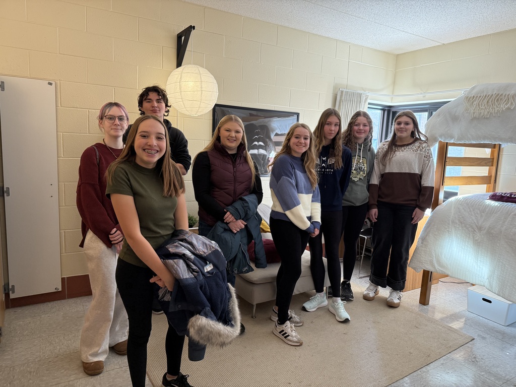 students looking at camera standing in a dorm at UMD