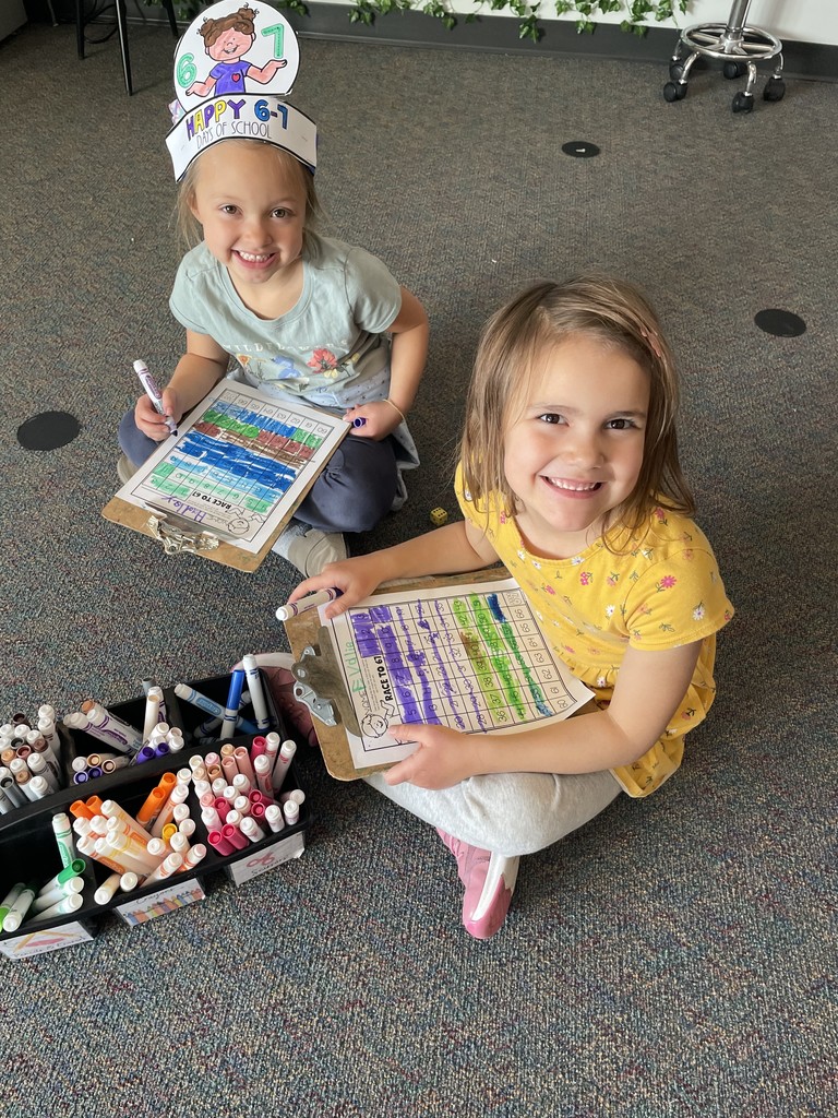 2 students coloring a worksheet