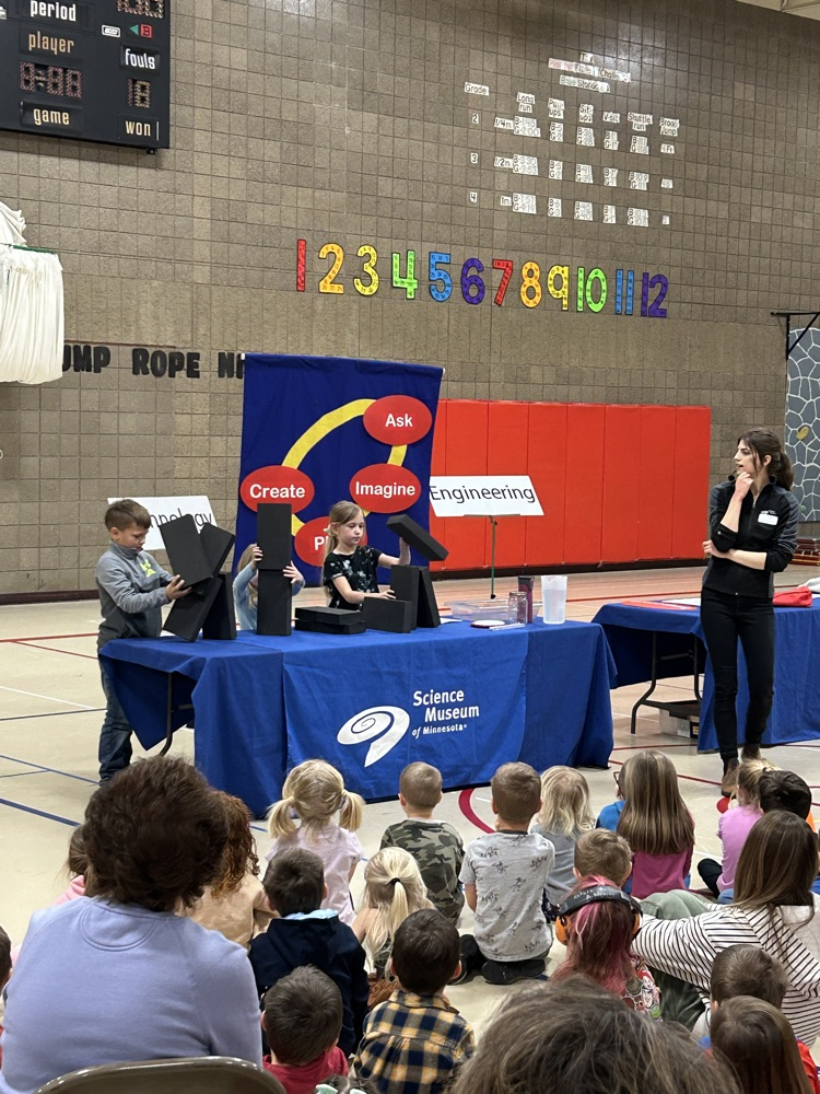 students building foam houses blocks in front of group 
