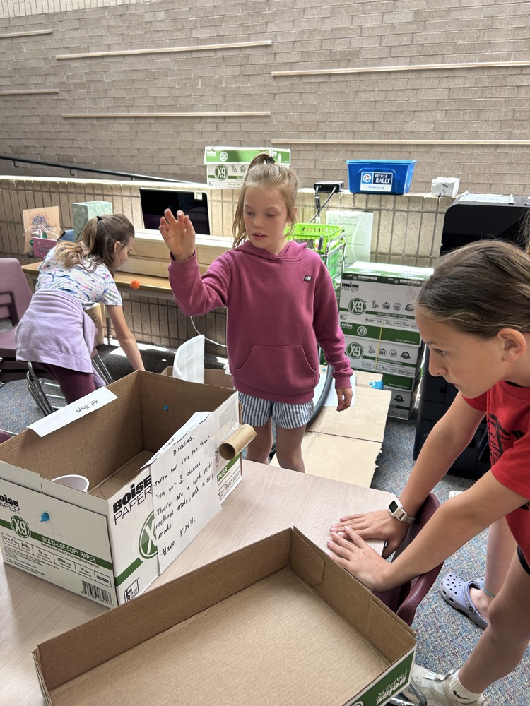 cardboard game and 2 girls