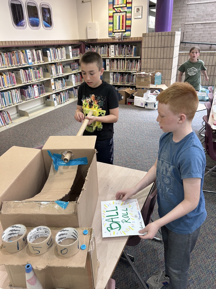 cardboard game and 2 boys