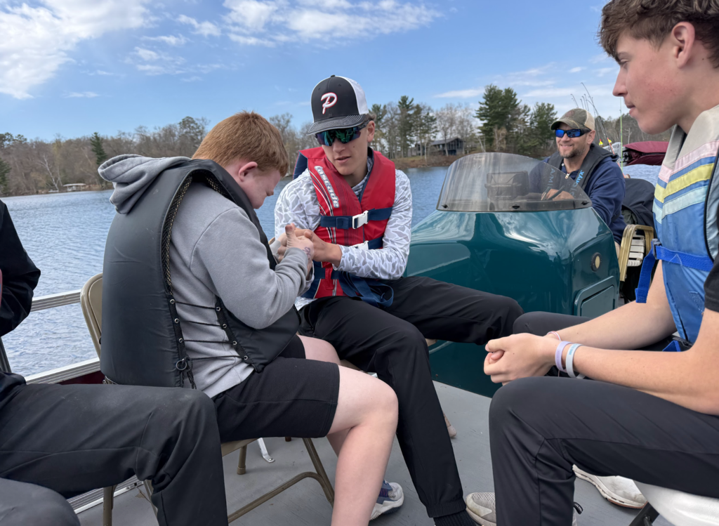 kids at camp confidence in a boat