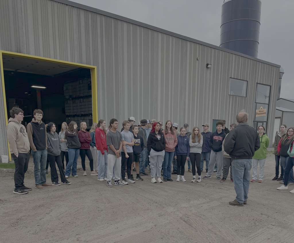 student in front of smude oil