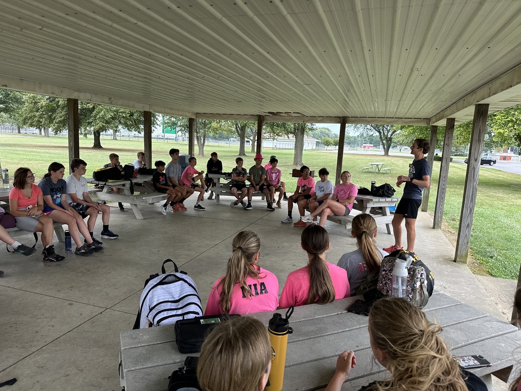 Professional runner talking to a cross country team
