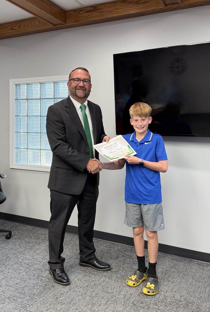 student posing with a certificate