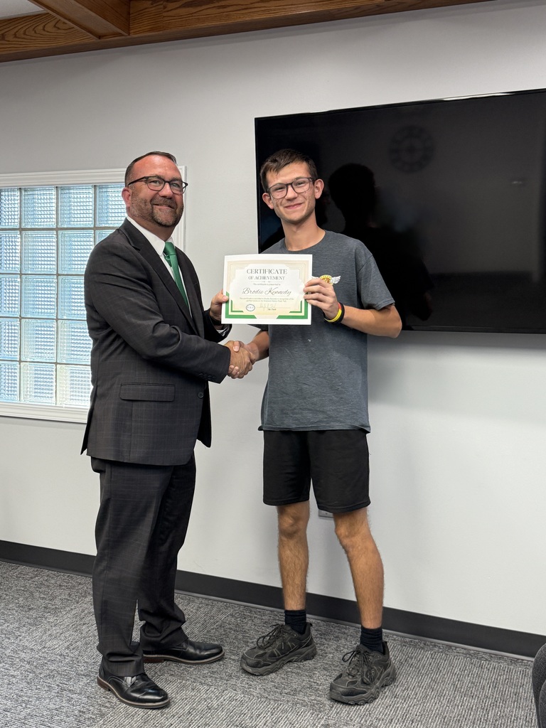 student posing with a certificate