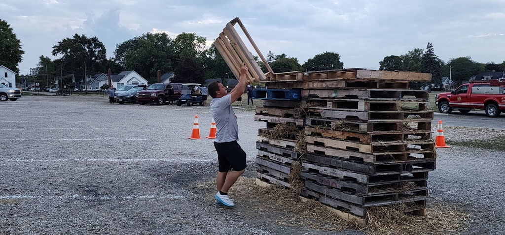 man stacking wood pallets