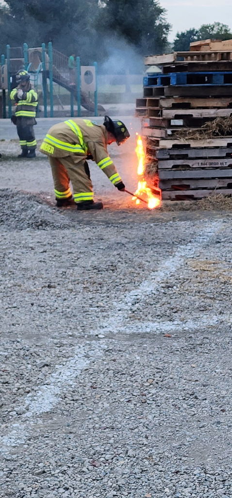 fireman starting a bonfire safely