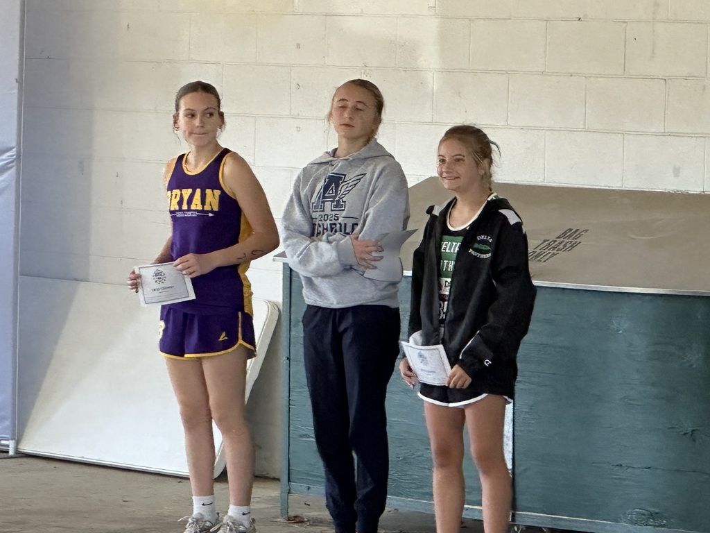 students at a podium accepting an award