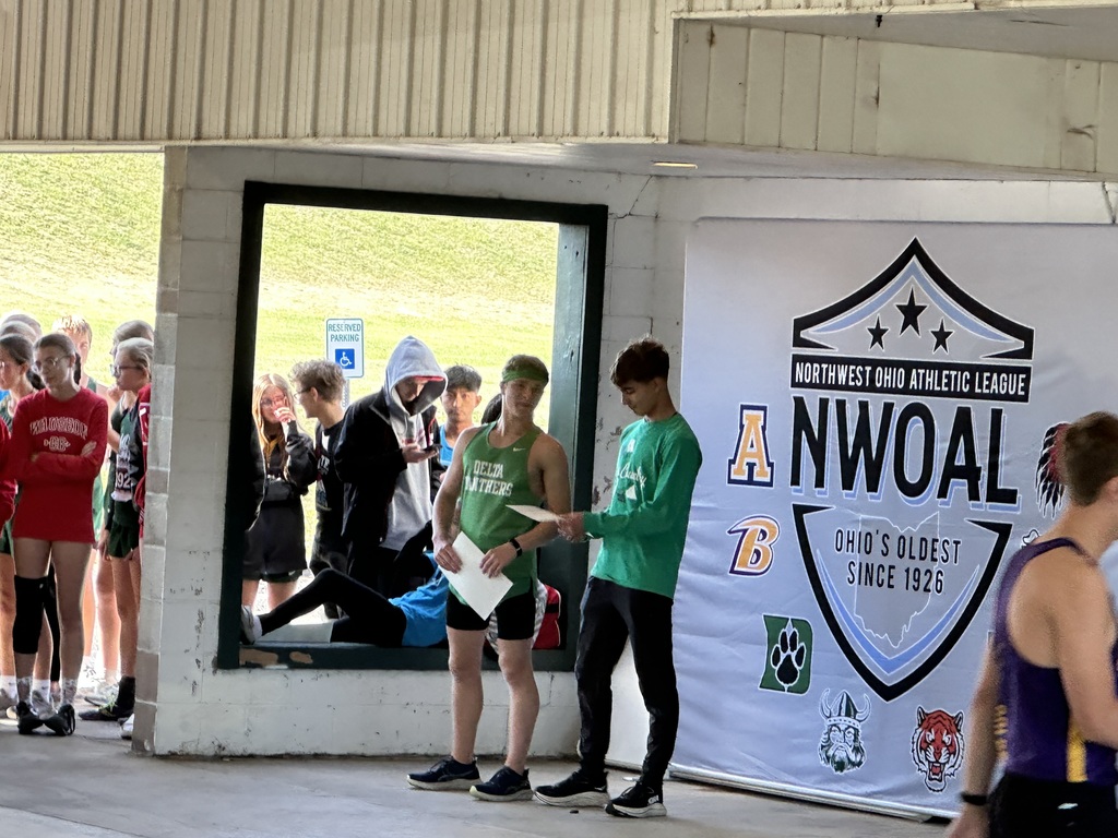 students at a podium accepting an award