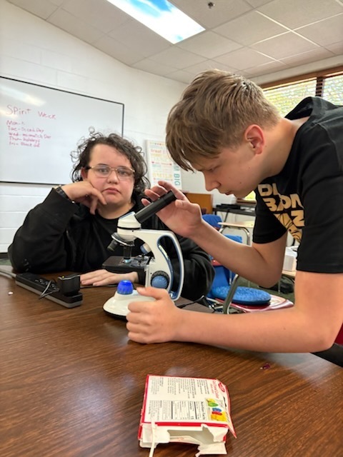 a student looking into a microscope