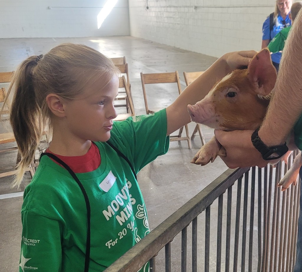 student posing with animals