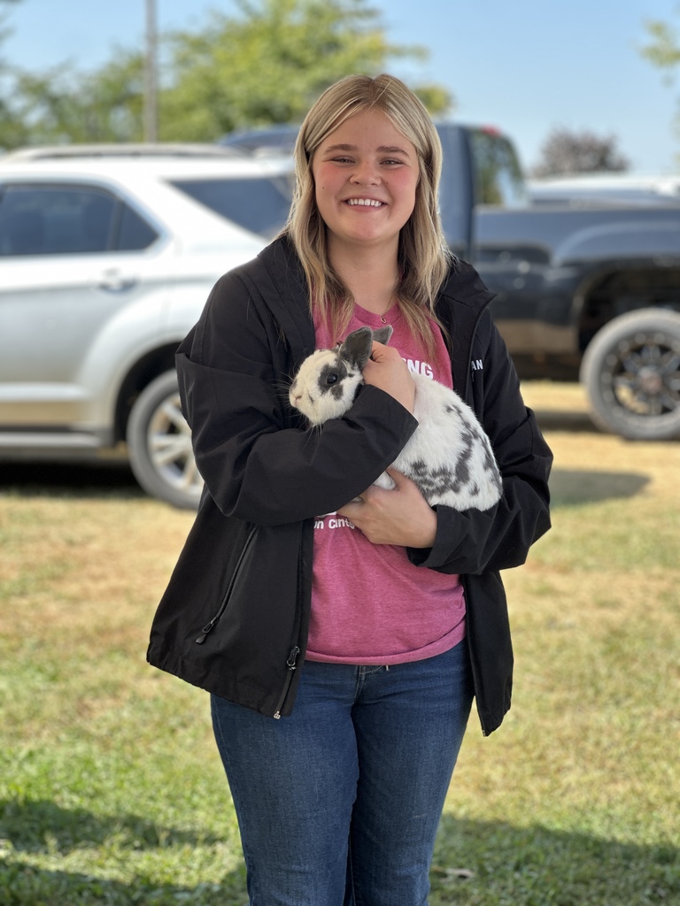 students posing with an animal